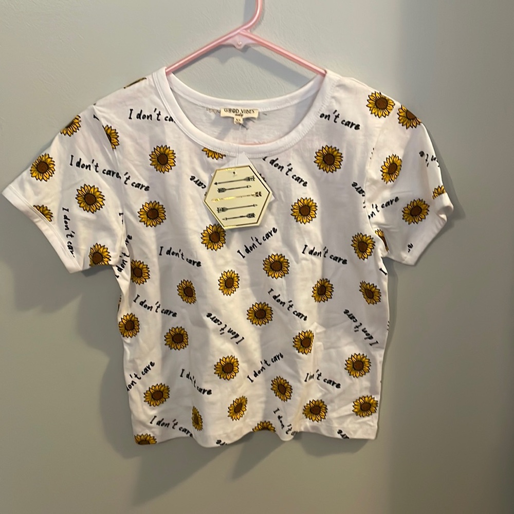 New Tee shirt with flower print and “i don’t care” message.